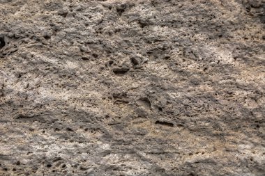 Pürüzlü taş yüzeye dokulu. Sarı kireç taşı. Arka plan görüntüsü. İnşaat malzemesi.