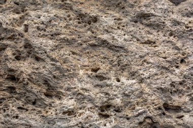 Pürüzlü taş yüzeye dokulu. Sarı kireç taşı. Arka plan görüntüsü. İnşaat malzemesi.