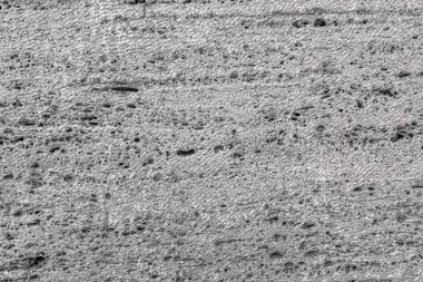 Pürüzlü taş yüzeye dokulu. Gri kireç taşı. Yüzey blok testere ile oluşturulur. Arka plan görüntüsü. İnşaat malzemesi.