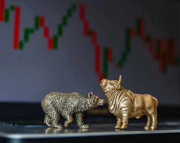 Bull and bear as symbols of stock trading on a blurred background of price graphics. The concept of symbolism of commodity and financial world markets.