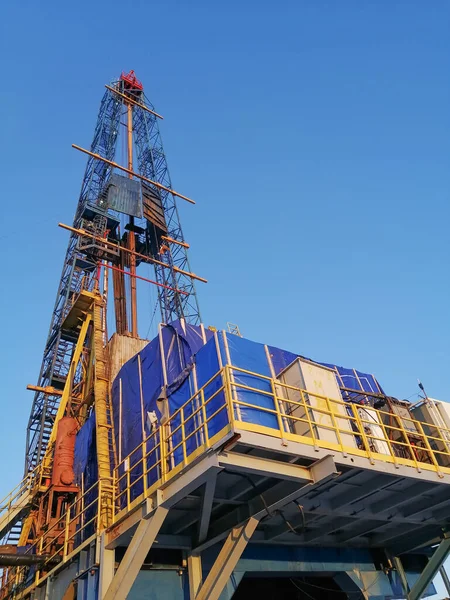 General view of the construction of a drilling rig for drilling oil and gas wells. Oil rig, equipment and communications. Drill pipes standing upright.