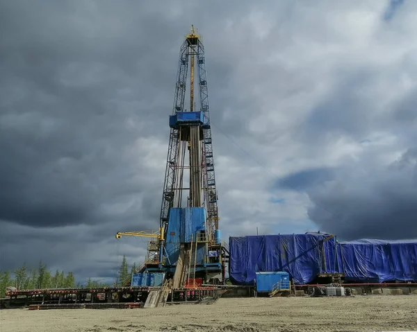 General view of the construction of a drilling rig for drilling oil and gas wells. Oil rig, equipment and communications. Drill pipes standing upright.