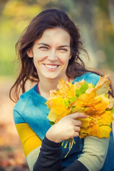 Gelukkige jonge vrouw in de herfst park — Stockfoto