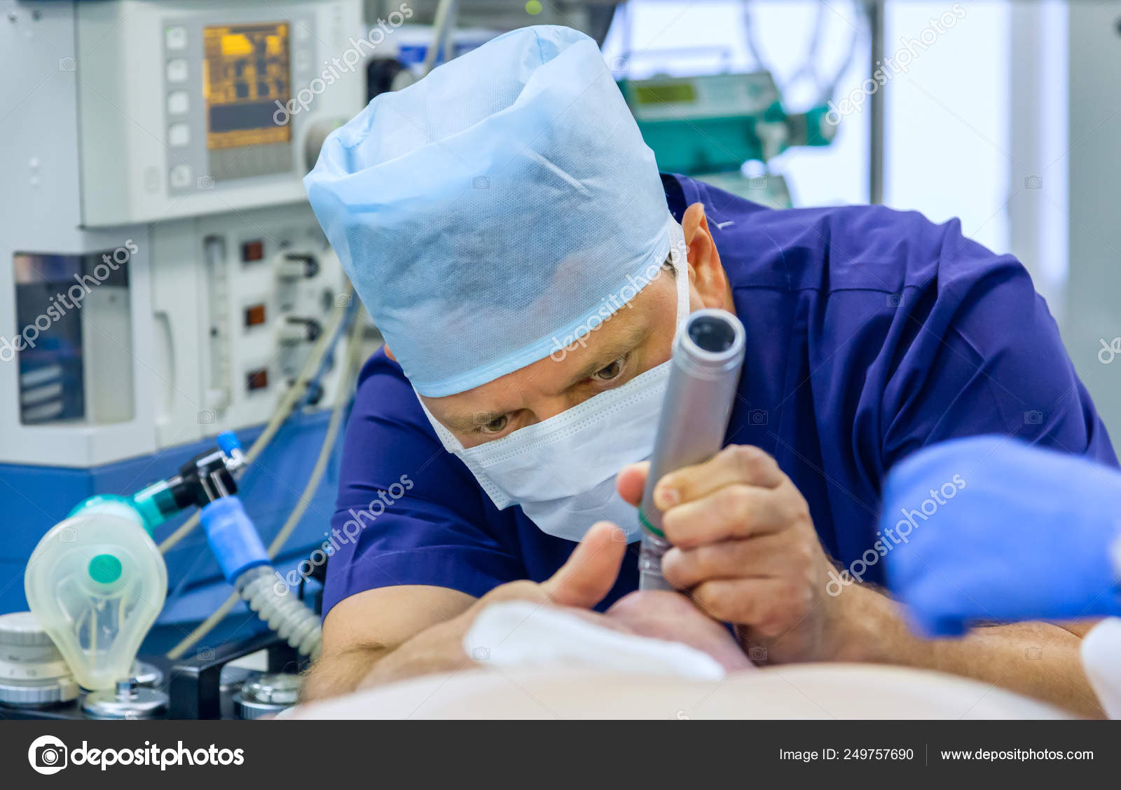 Anesthesiologist performing tracheal intubation Stock Photo by