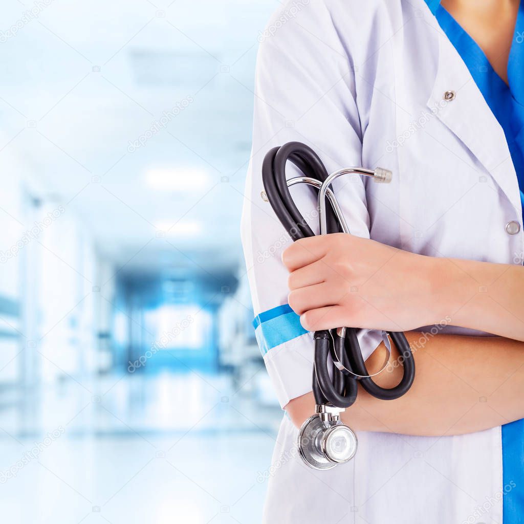 Unrecognizable Female Doctor with Stethoscope in Hand in the Hal