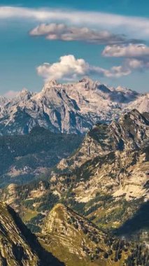 Slovenya 'nın Julian Alp Dağları' ndaki Triglav Ulusal Parkı 'nın kayalık dağları üzerinde hızla ilerleyen Vejetaryen Zaman kayalıkları. Sıcak yaz ışığı ve katmanlı zirveler. Seyahat, yürüyüş ve açık hava için ideal.