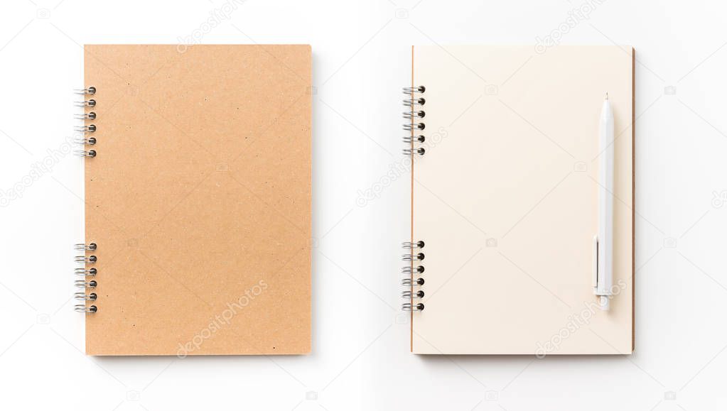Design concept - Top view of kraft spiral notebook, blank page and pen isolated on white background for mockup