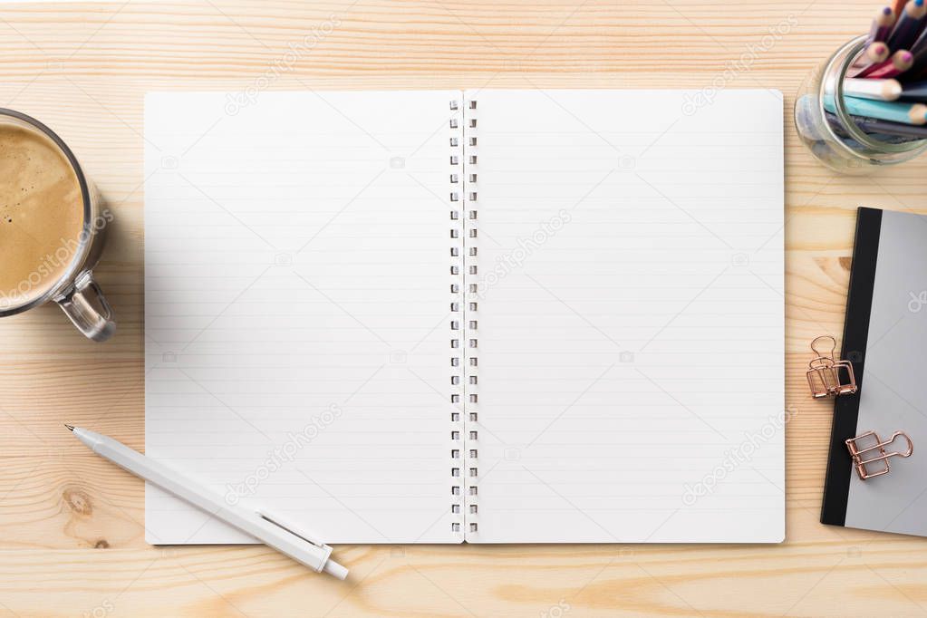 Design concept - Top view of lot of stationary, like black spiral notebook and wood mechanical pencil... on wood table background for mockup