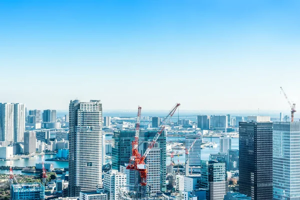 stock image Asia Business concept for real estate and corporate construction - panoramic modern city skyline bird eye aerial view with crane near tokyo tower under bright sun and vivid blue sky in Tokyo, Japan