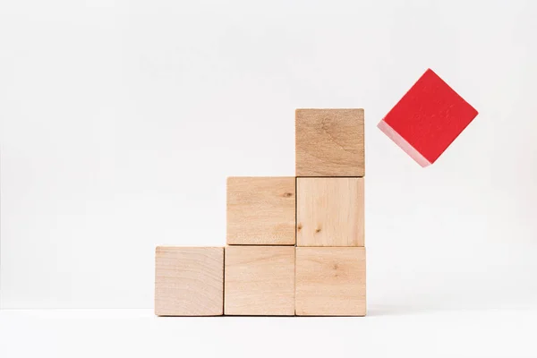 Business and design concept - abstract geometric real wooden cube pyramid on white floor background and it's not 3D render. It's the symbol of make a mistake, fall into a trap — Stock Image Business Design Concept Abstract Geometric Real Wooden Cube Pyramid White Stock Photo