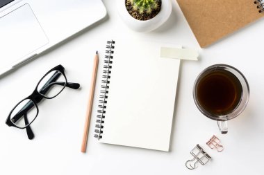 İş kavramı - beyaz okul sırası geçmiş ile defter, kahve, akıllı telefon, kaktüs ve klibi mockup tasarım için en iyi görünümü
