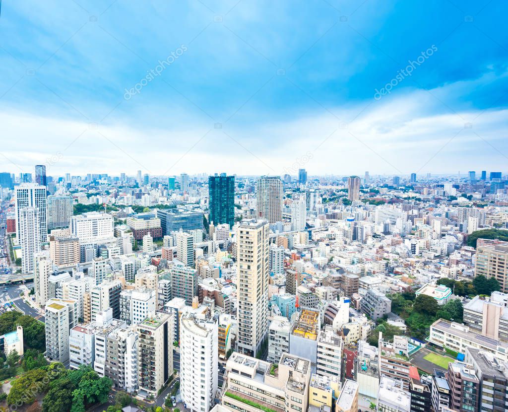 Business and culture concept - panoramic modern city skyline bird eye aerial view from tokyo tower under dramatic sunny and morning blue cloudy sky in Tokyo, Japan