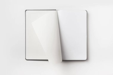 Business concept - Top view collection of black hardcover notebook, white open & flip curl rolled page isolated on background for mockup clipart