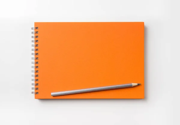 Tasarım konsepti - turuncu spiral defter ve renk kalem toplama mockup için beyaz arka plan üzerinde izole üstten görünüm