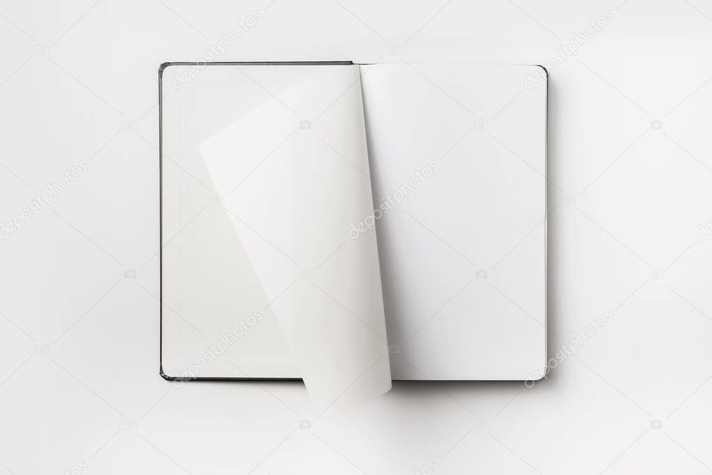 Business concept - Top view collection of black hardcover notebook, white open & flip curl rolled page isolated on background for mockup