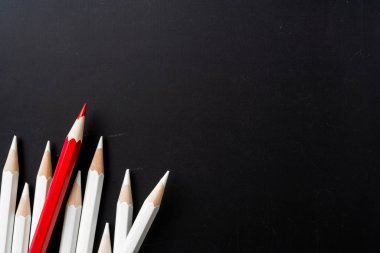 İş ve tasarım konsepti - beyaz kalem ve siyah arka plan üzerinde bir renk kalem çok. Liderlik, takım çalışması, başarı ve benzersiz sembolü.