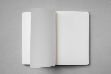 Tasarım konsepti - beyaz dizüstü bilgisayarın üst görünümü nde boş açık, döndürve sahte sayfa ile gri arka plan üzerinde mockup için.