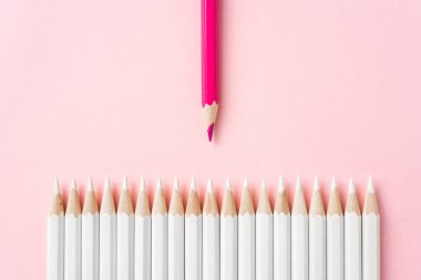 İş ve tasarım konsepti - beyaz kalem ve pembe kağıt arka plan üzerinde bir renk kalem çok. Liderlik, takım çalışması, başarı ve benzersiz sembolü.