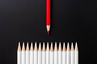 İş ve tasarım konsepti - beyaz kalem ve siyah arka plan üzerinde bir renk kalem çok. Liderlik, takım çalışması, başarı ve benzersiz sembolü.