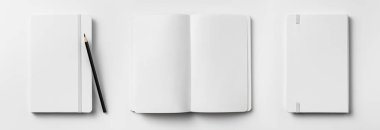 Ön kapalı manzaralı, elastik bant ve kalemle açılan ve geri dönen dizüstü bilgisayarlar. 