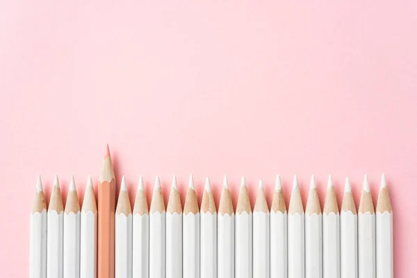 商业和设计理念 粉红色纸背景上的白色铅笔和一支彩色铅笔 — 图库照片
