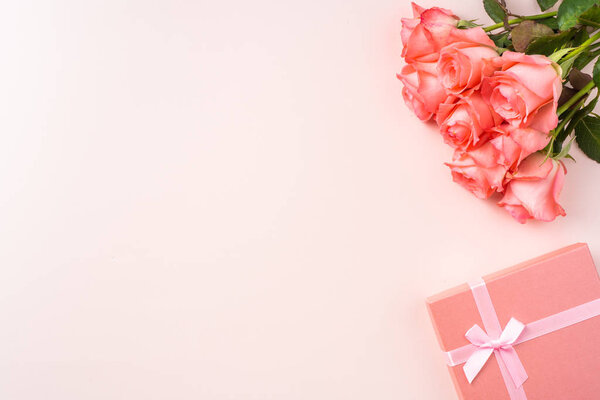 Bouquet of pink roses, gift box on pink background