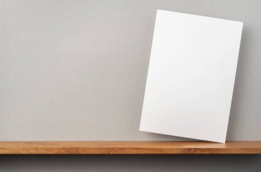 A4 sert kağıt kitapçık ve mockup için gri duvar üzerinde duruyor