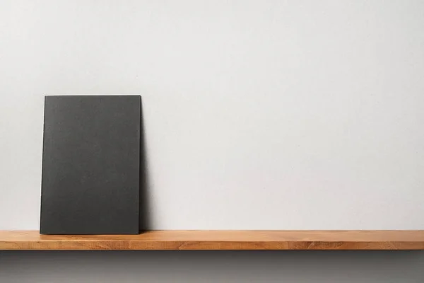 Black Magazine Standing Bookshelf Grey Wall Mockup — Stock Photo, Image