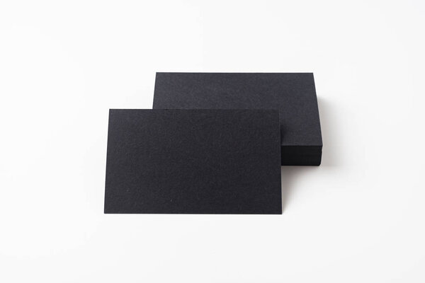 Black business cards isolated on white background for mockup