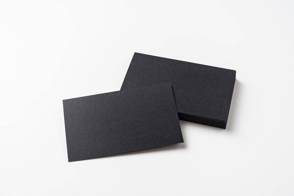 Black business cards isolated on white background for mockup