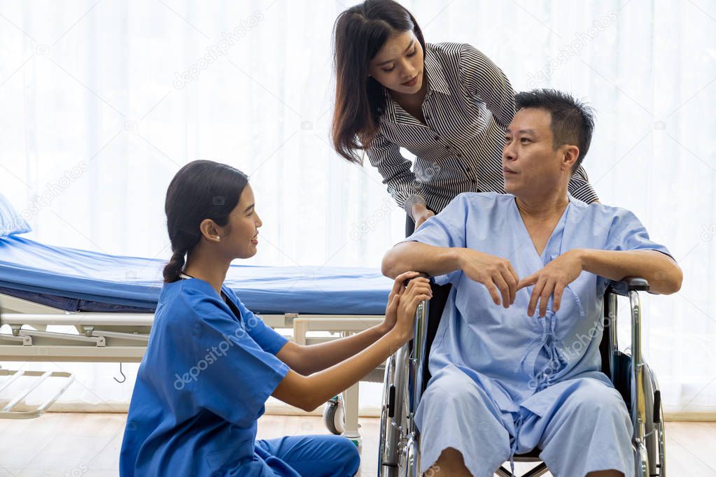 Physical therapist explain treatment method to senior patient and relative
