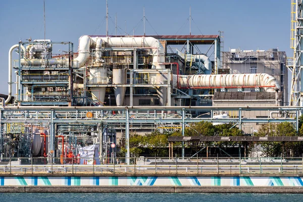 Chemical Factory plant with gas storage and structure of pipeline with smoke from smokestack in Kawasaki City near Tokyo Japan