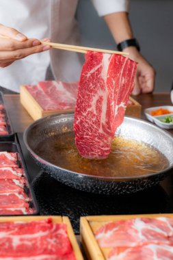 Cooking of japanese wagyu beef Shabu Shabu set hot pot clipart