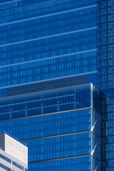 Urban abstract, facade with windows of business center office building with reflections and colors.