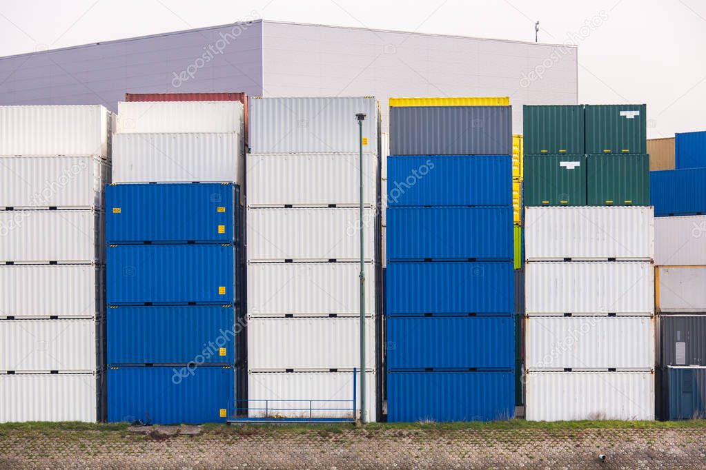 Cargo Containers Goods Stack at the Pier docks port waiting for international sea freight transportation in Rotterdam Port of Netherlands