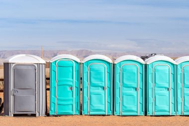 Row of public Portable mobile toilets on the street outdoor clipart