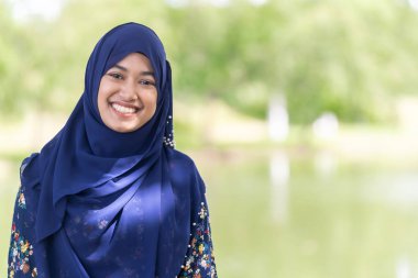 Portrait of good-looking Happy young teenager Muslim islamic asian university girl clipart