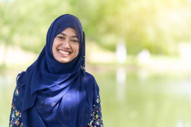 Portrait of good-looking Happy young teenager Muslim islamic asian university girl clipart