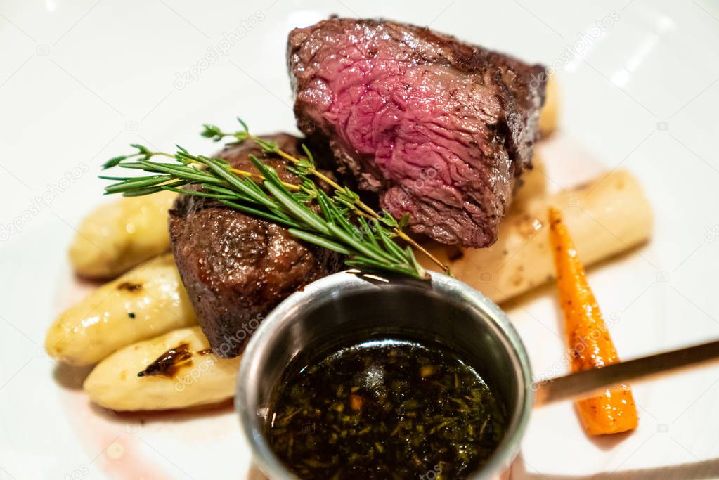 Grilled Beef Tenderloin wagyu with white asparagus decorate with edible flowers