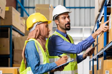 Ortadoğu Türk beyaz depo müdürü, dağıtım merkezindeki envanter lojistik rotası hakkında Asyalı Müslüman bir depocu ile konuştu. İş deposu envanteri ve lojistik konsept için.