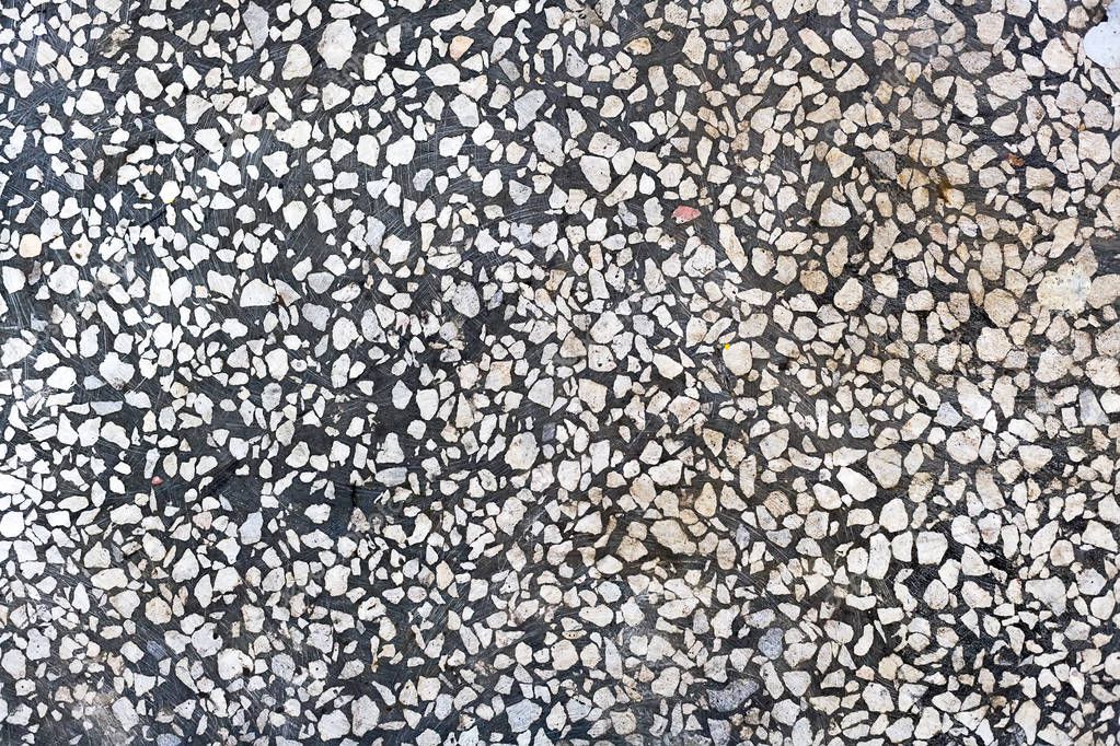Abstract background. Gray concrete floor with white stone chips. Smooth polished surface