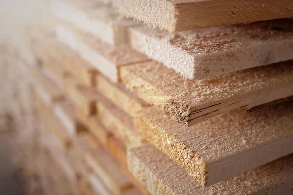 Стек натуральных грубых деревянных досок крупным планом. Хранение древесины в столярной мастерской или на лесопилке — стоковое фото