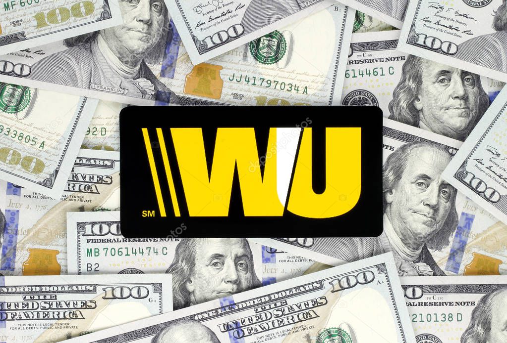 Kiev, Ukraine - September 18, 2018: Western Union logo printed on paper, cut and placed on money background. The Western Union Company is an American financial services and communications company