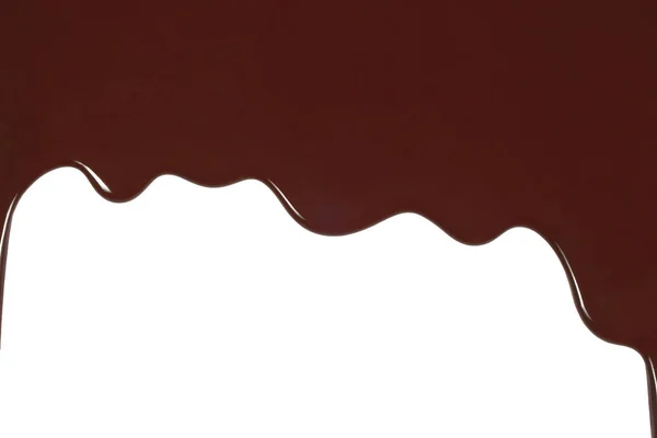 Melted chocolate dripping on white background — Stock Photo, Image