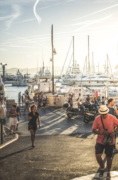 Marina with Boats and tourists on sunset. St Tropez resort in France