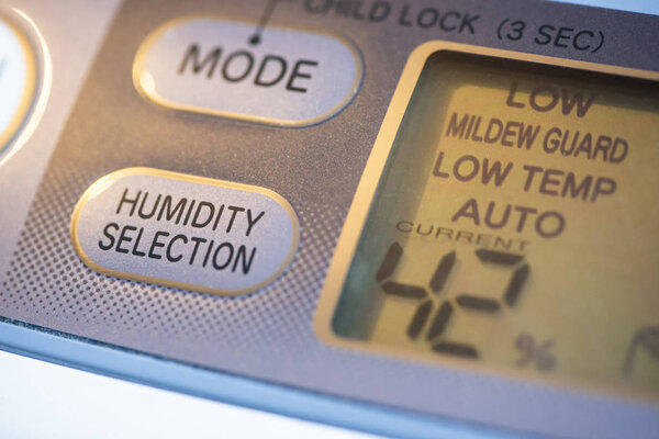 Air Purifier and dehumidifier. Concept for dehumidifying room. Humidity selection button. Humidity percentage display. Close-up device.