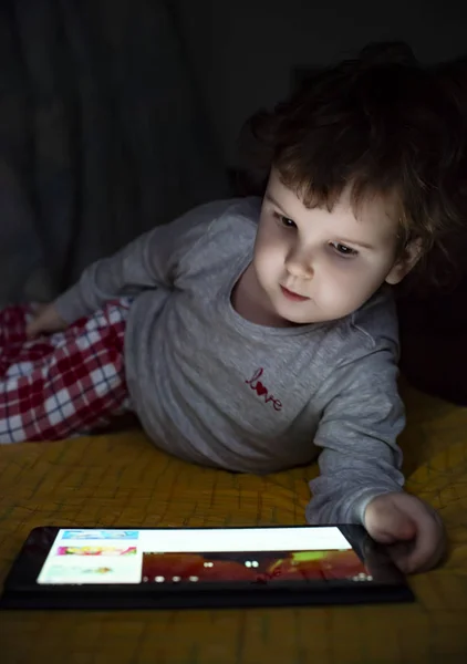 Küçük Kız Yatakta Onun Tablet Izliyor Işıklı Çocuk Yüz Dan — Stok fotoğraf