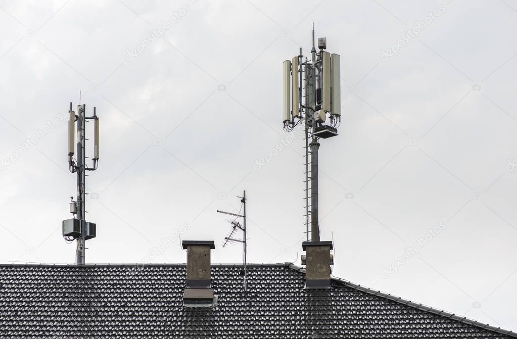 5G antennas on top of house. Antennas and transmitters on roof.