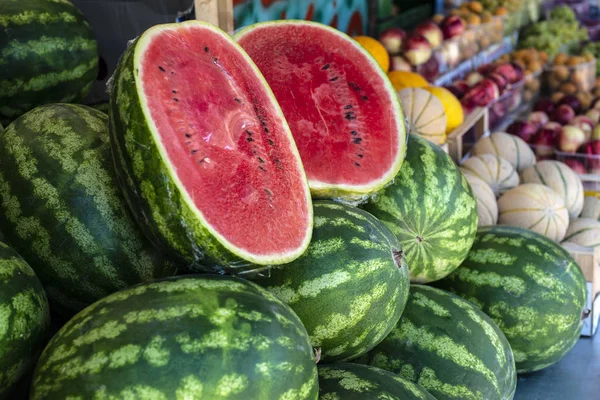 Watermelons on shelf. Cutted watermelon on street market — Stock Photo, Image