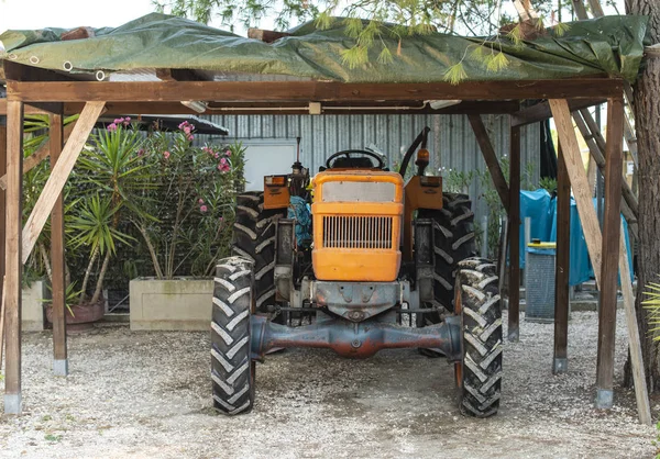 Farm tractor parked in the garage — Stock Photo, Image